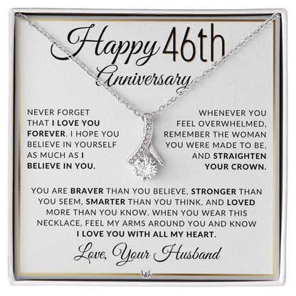 Silver 46th birthday necklace with a rhinestone pendant, presented on a square white gift card with anniversary messages and the text 'Love, Your Husband'.