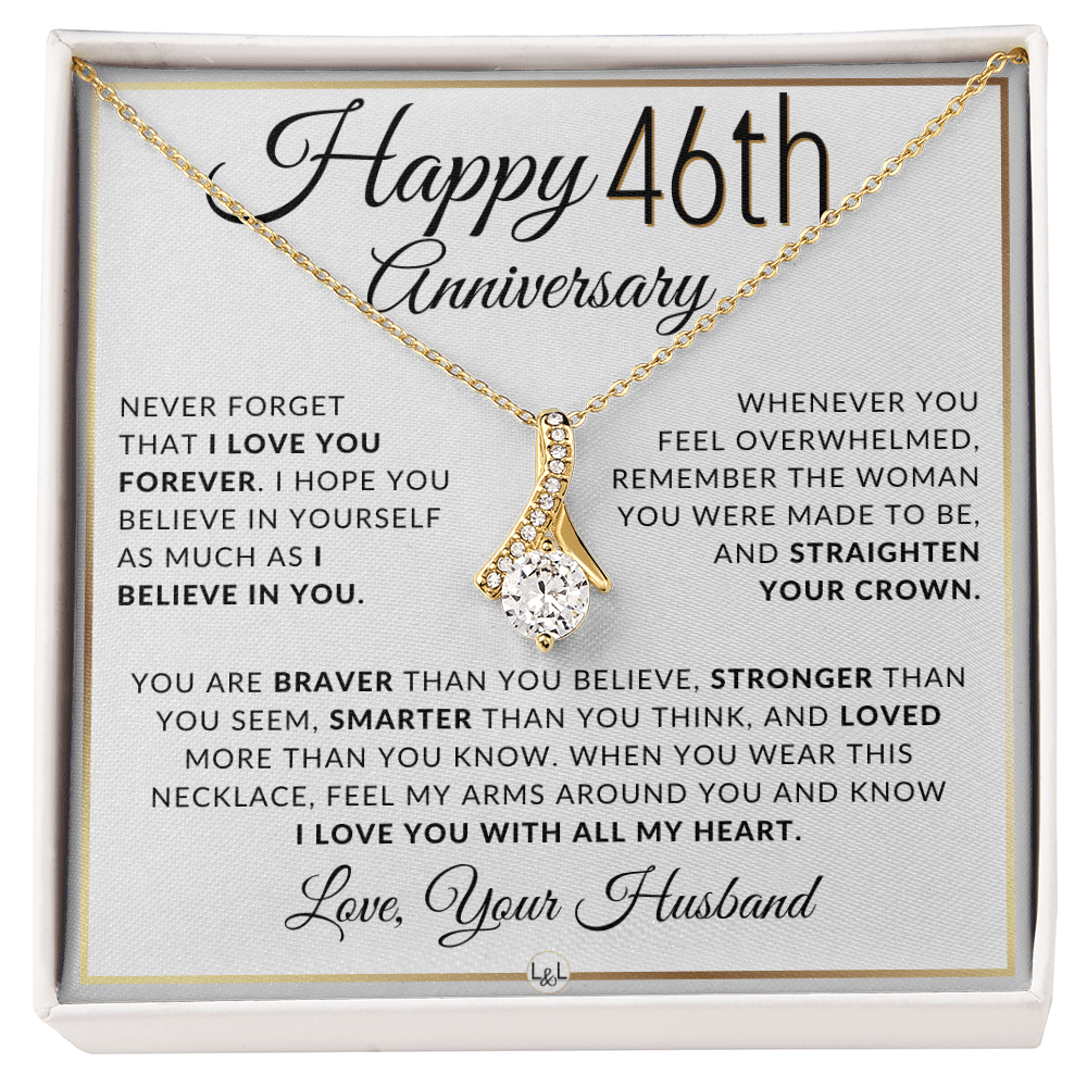 Gold 46th birthday necklace with a rhinestone pendant, presented on a square white gift card with anniversary messages and the text 'Love, Your Husband'.