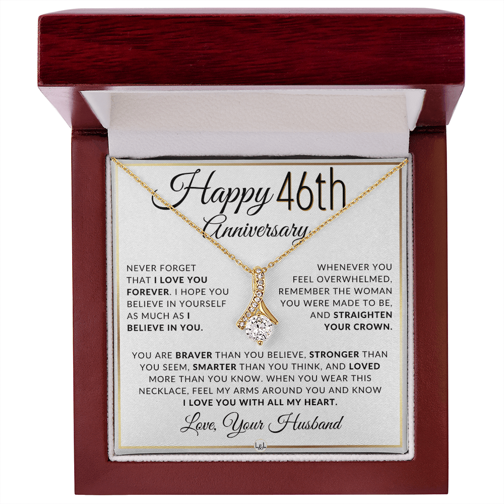 Gold 46th birthday necklace with a rhinestone pendant, presented on a square white gift card with anniversary messages and the text 'Love, Your Husband'.