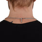 Back view of person wearing a silver curb chain necklace with lobster clasp and extender chain, shown against a black top.
