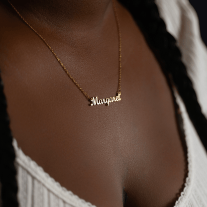 Woman wearing a custom gold name necklace engraved with the name Margaret