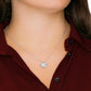 Silver cubic zirconia pendant necklace worn by woman on delicate chain