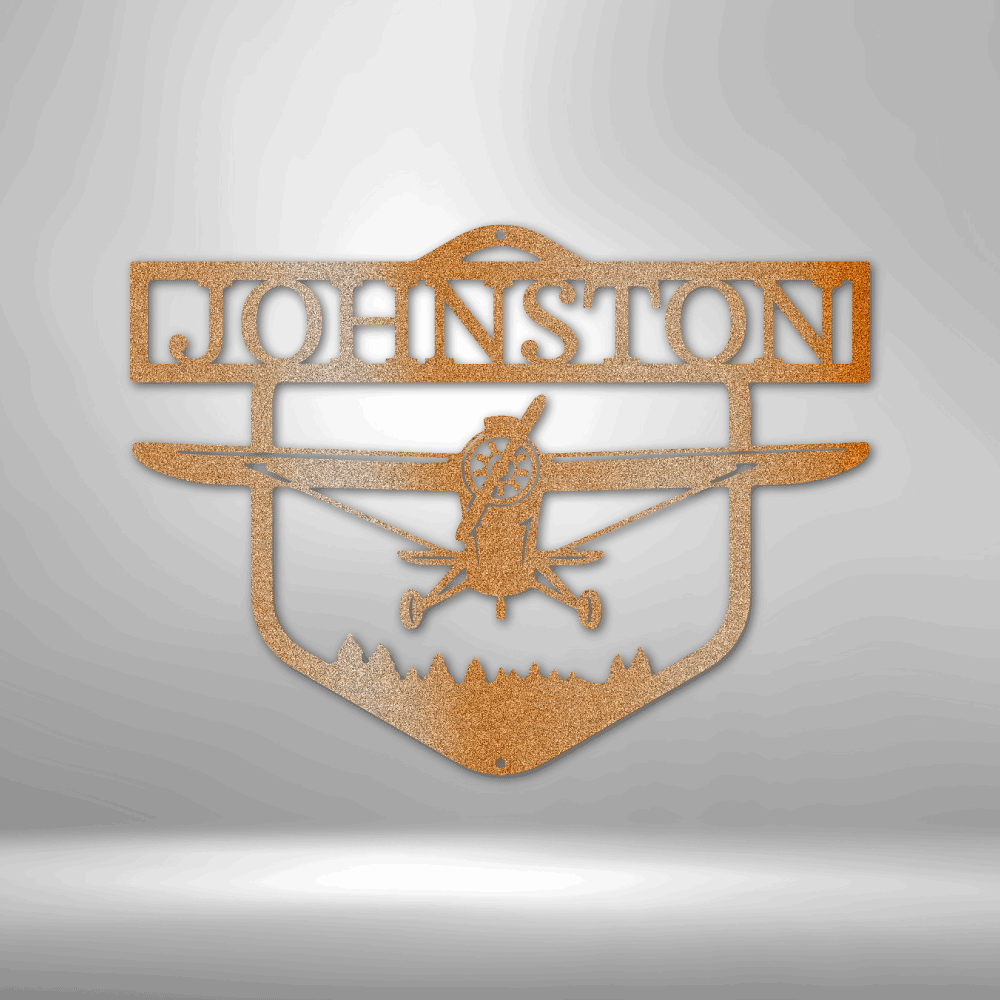 Decorative metal sign with airplane silhouette and 'Johnston' text on a white brick wall background