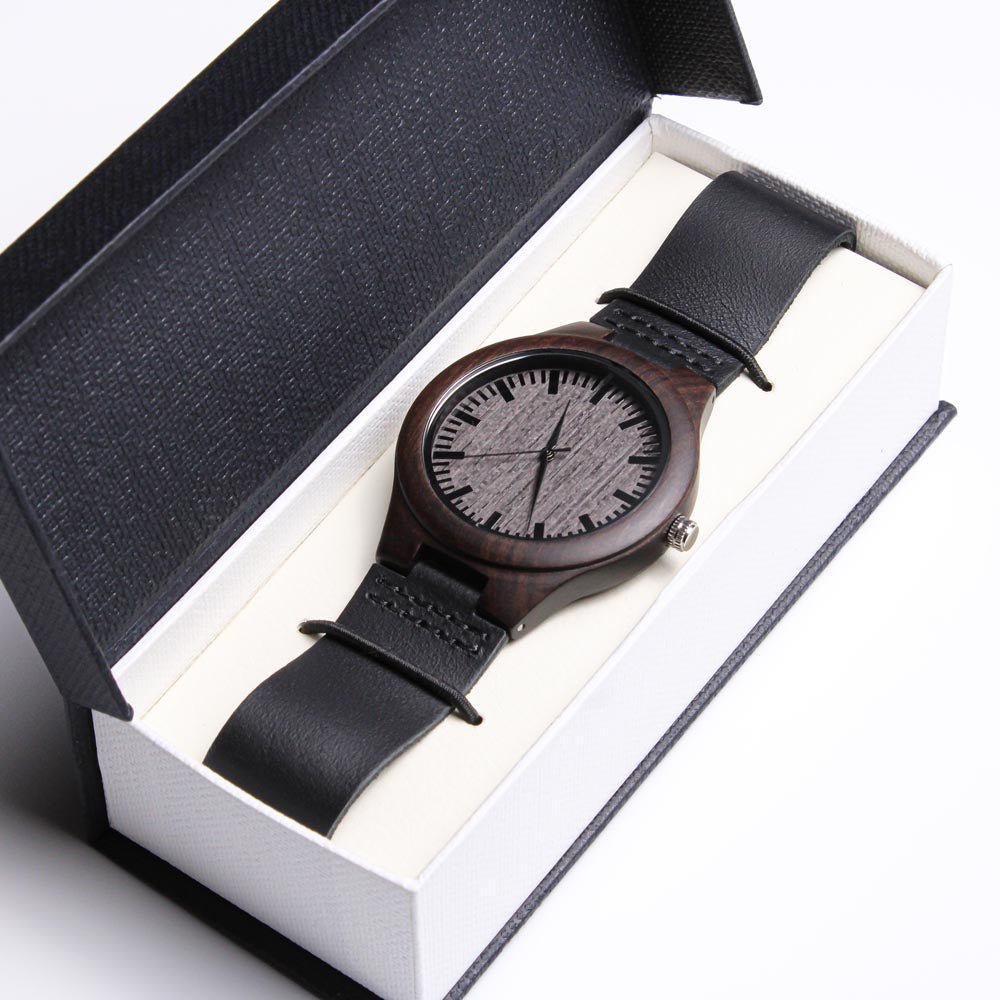 Dark wood men’s watch with black leather strap displayed in a premium gift box